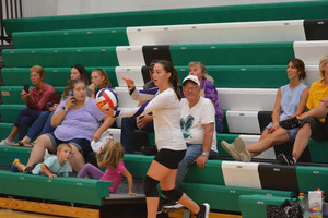 Senior and Team Captain Kailey Kupfer tosses up a serve during a match in Rhinelander earlier this season.